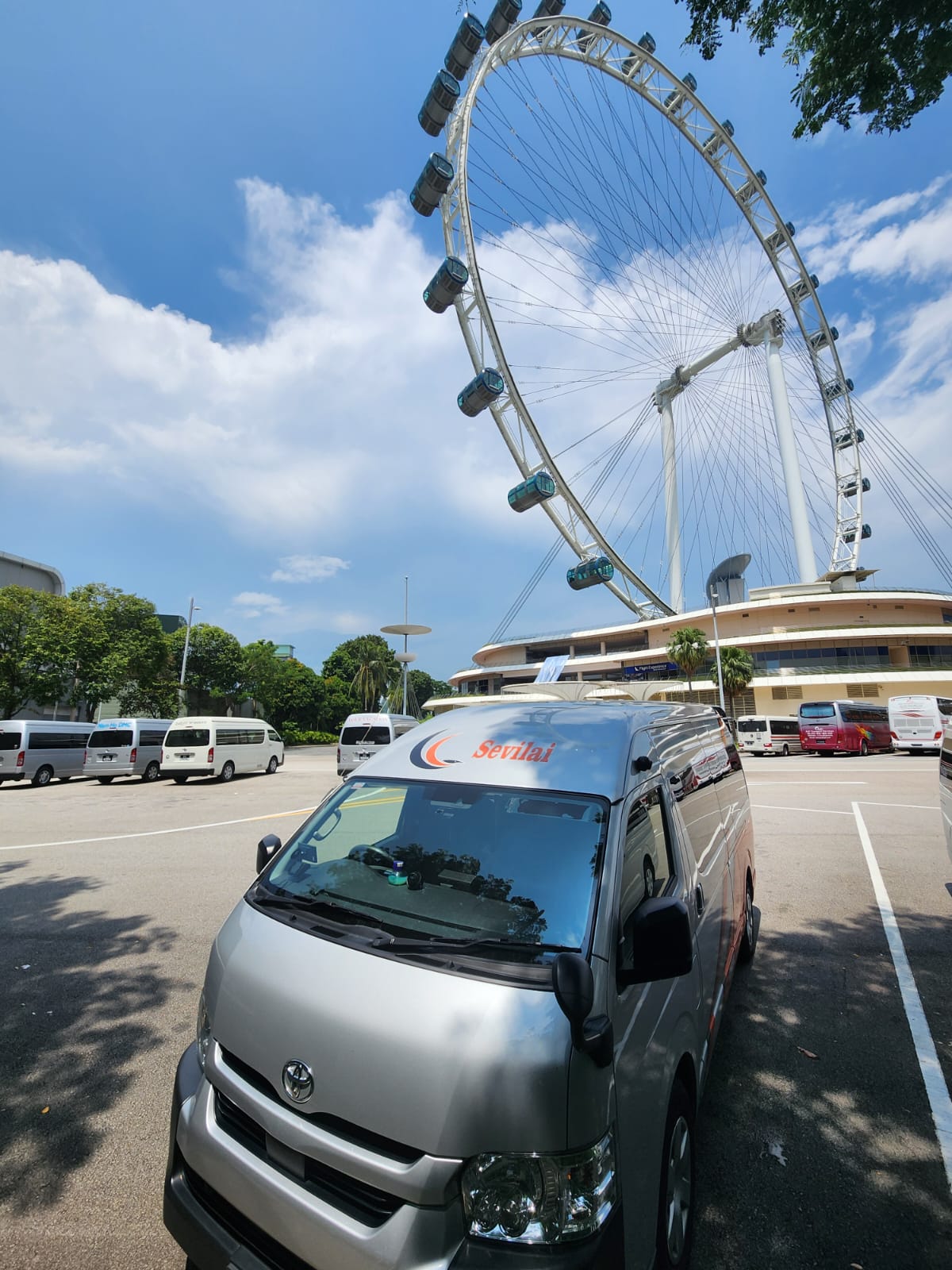 Sevilai Transport vehicles, team, and services in operation for group travel solutions.